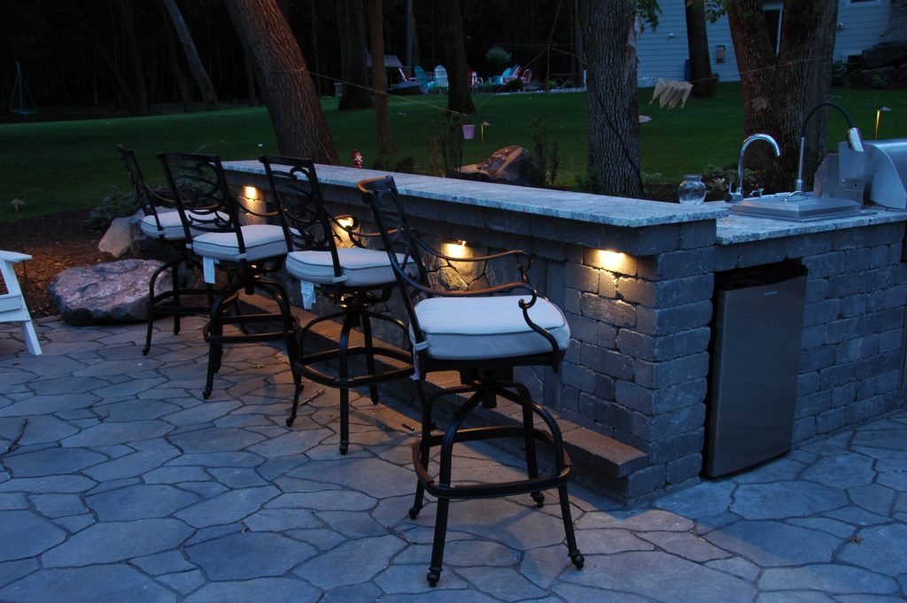 Mid-sized elegant backyard stone patio kitchen photo in Minneapolis with no cover