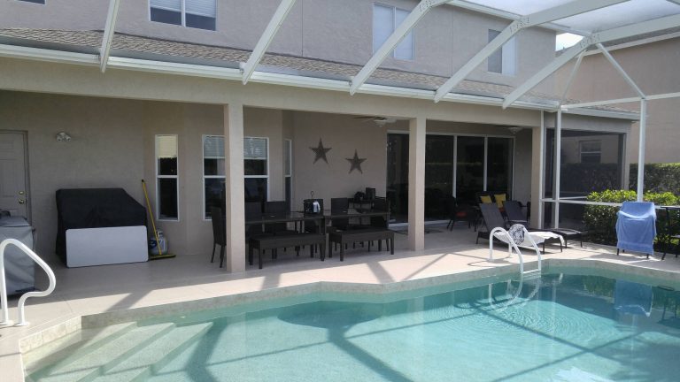 Mid-sized elegant backyard tile and custom-shaped pool photo in Miami