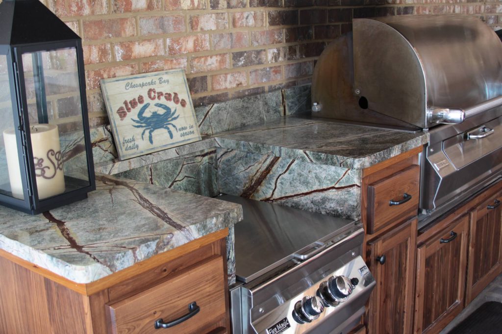 Mid-sized elegant backyard tile patio kitchen photo in Atlanta with a roof extension