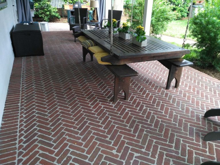 Mid-sized elegant brick porch photo in Jacksonville with a roof extension