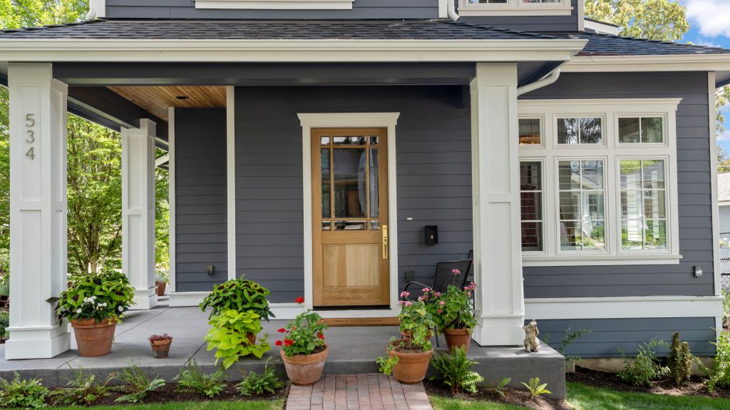 Mid-sized elegant brick porch photo in Portland with a roof extension by The WhiteHouse Collection | Outdoor Photos | Porch | Landscaping | Landscape Design | Outdoor Living Space | Porch Design Ideas | Outdoor Living Space Ideas | Backyard Design