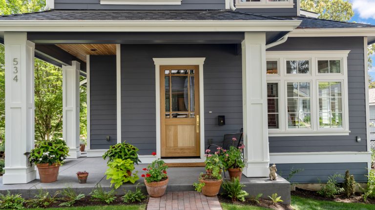 Mid-sized elegant brick porch photo in Portland with a roof extension by The WhiteHouse Collection | Outdoor Photos | Porch | Landscaping | Landscape Design | Outdoor Living Space | Porch Design Ideas | Outdoor Living Space Ideas | Backyard Design