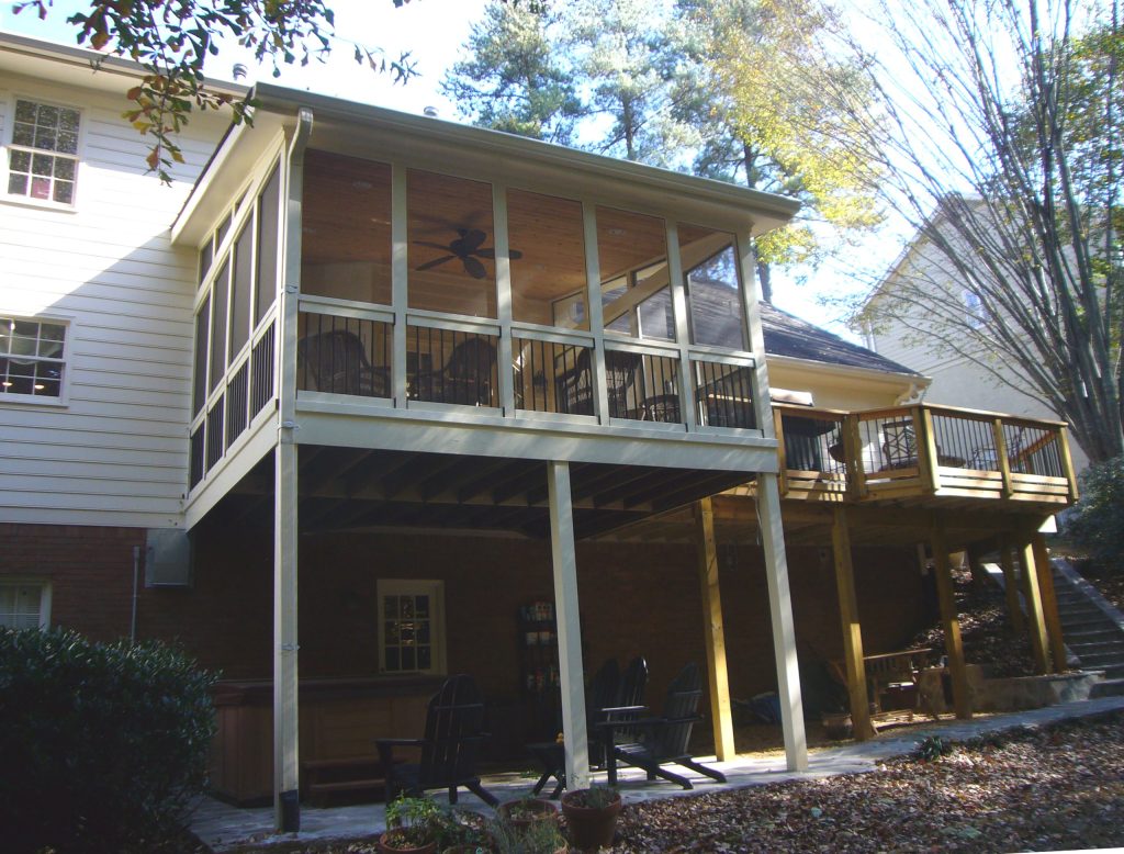 Mid-sized elegant screened-in back porch photo in Atlanta with a roof extension by Synergy Outdoor | Outdoor Photos | Porch | Landscaping | Landscape Design | Outdoor Living Space | Porch Design Ideas | Outdoor Living Space Ideas | Backyard Design
