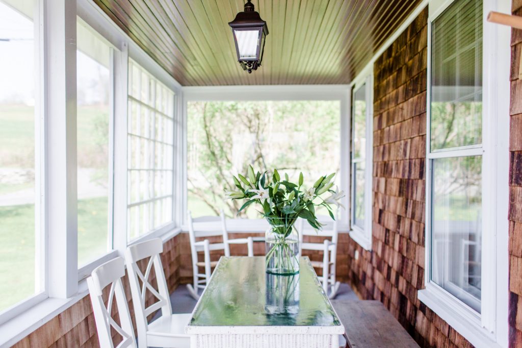 Mid-sized elegant screened-in front porch photo in San Francisco with a roof extension by Cassandra Crain Design, LLC | Outdoor Photos | Porch | Landscaping | Landscape Design | Outdoor Living Space | Porch Design Ideas | Outdoor Living Space Ideas | Backyard Design