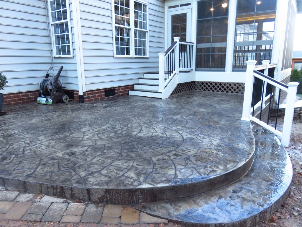 Mid-sized elegant stamped concrete screened-in back porch photo in Raleigh with a roof extension by Stafford Construction | Outdoor Photos | Porch | Landscaping | Landscape Design | Outdoor Living Space | Porch Design Ideas | Outdoor Living Space Ideas | Backyard Design