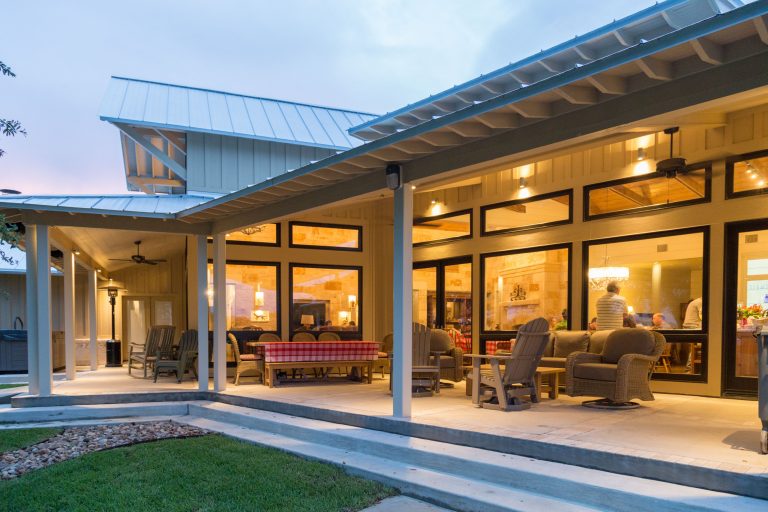 Mid-sized farmhouse backyard concrete patio kitchen photo in Houston with a roof extension