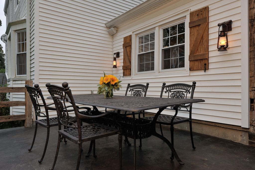 Mid-sized farmhouse backyard concrete patio kitchen photo in New York with no cover