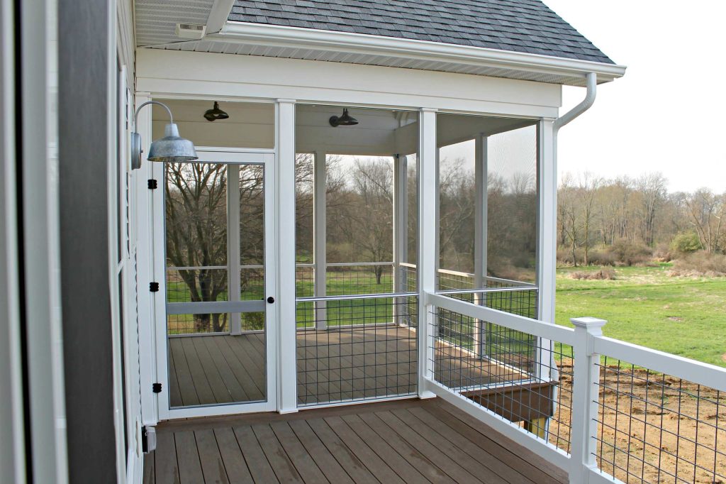Mid-sized farmhouse screened-in back porch idea in Other with decking and a roof extension by Clutter Funk | Outdoor Photos | Porch | Landscaping | Landscape Design | Outdoor Living Space | Porch Design Ideas | Outdoor Living Space Ideas | Backyard Design