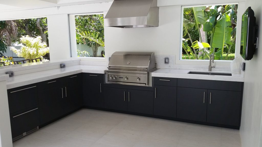 Mid-sized island style backyard concrete paver patio kitchen photo in Other with no cover