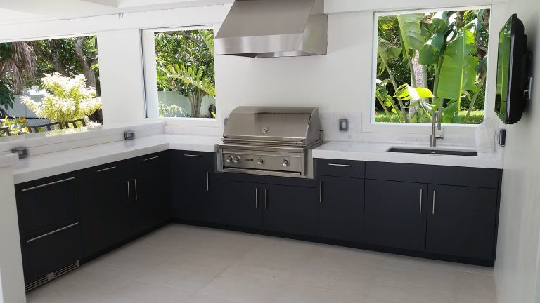 Mid-sized island style backyard concrete paver patio kitchen photo in Other with no cover