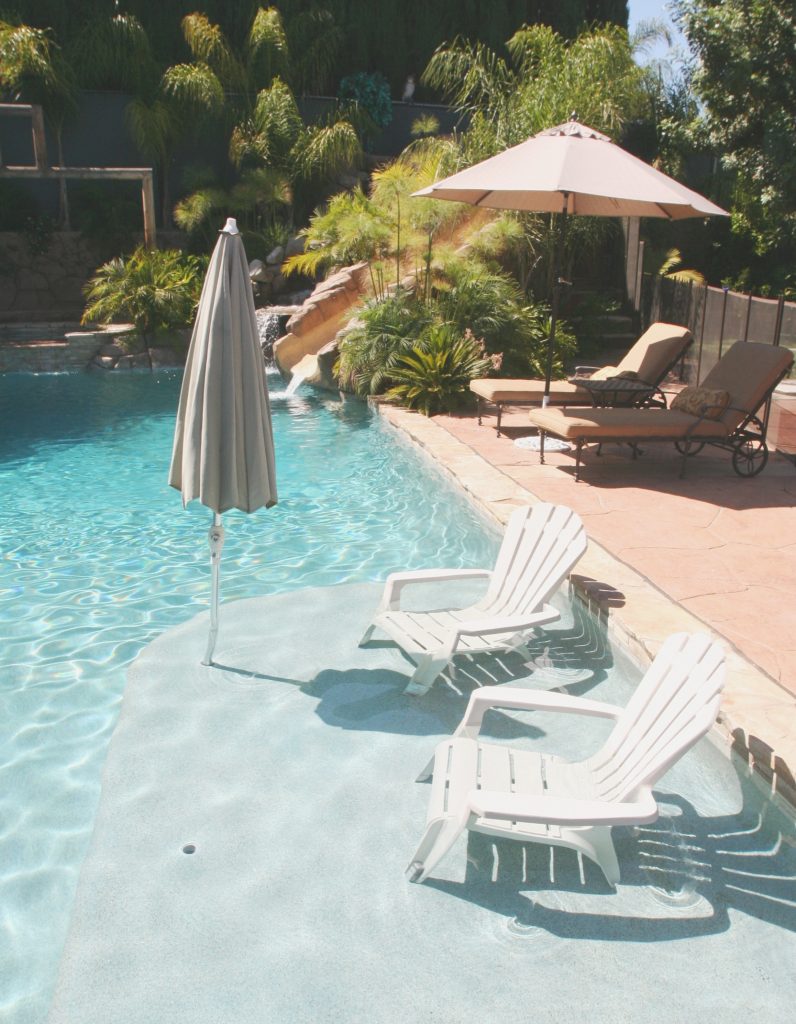 Mid-sized island style backyard stone and custom-shaped lap water slide photo in Los Angeles