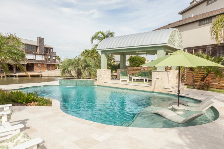 Mid-sized island style backyard tile and custom-shaped lap hot tub photo in Houston