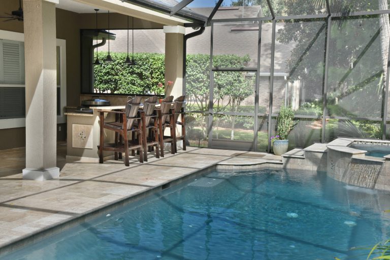 Mid-sized island style backyard tile patio kitchen photo in Jacksonville with a roof extension