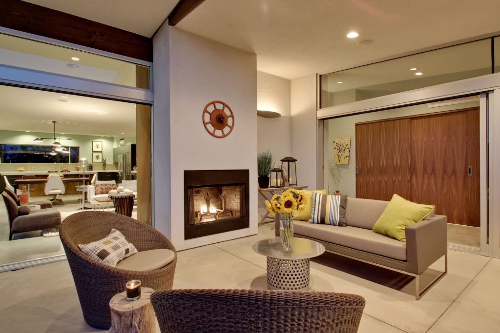Mid-sized mid-century modern concrete side porch idea in Los Angeles with a fire pit and a roof extension by Moderne Builders | Outdoor Photos | Porch | Landscaping | Landscape Design | Outdoor Living Space | Porch Design Ideas | Outdoor Living Space Ideas | Backyard Design