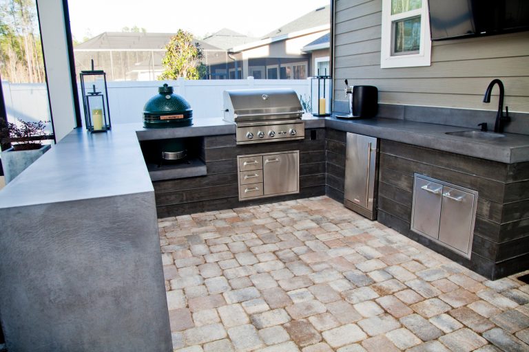 Mid-sized minimalist backyard brick patio kitchen photo in Jacksonville
