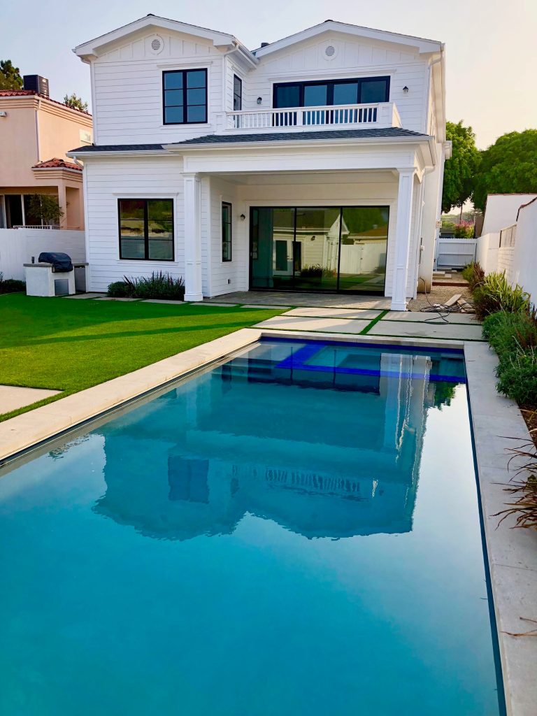 Mid-sized minimalist backyard concrete and custom-shaped lap pool photo