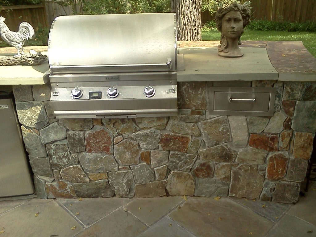 Mid-sized minimalist backyard concrete paver patio kitchen photo in Kansas City with a pergola