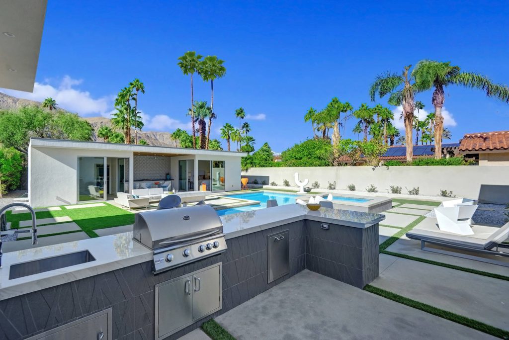 Mid-sized minimalist backyard concrete paver patio kitchen photo in Los Angeles with no cover