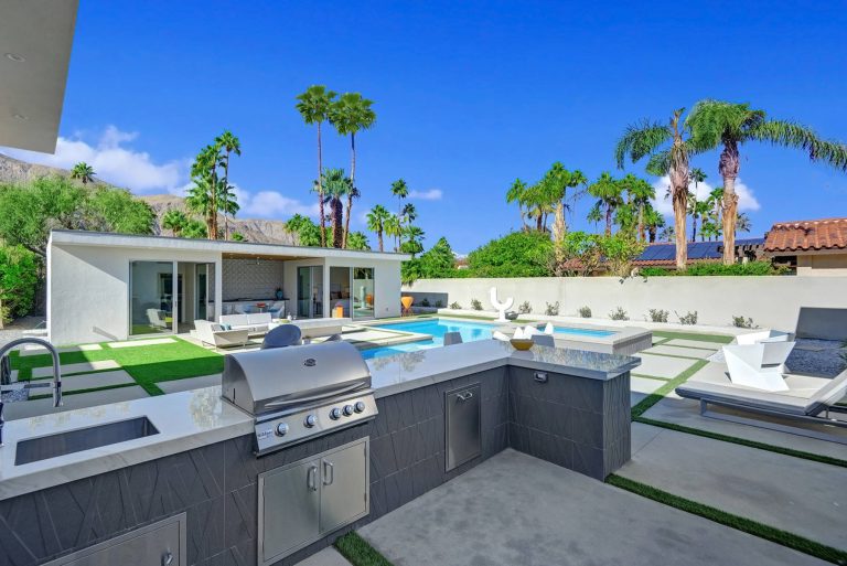 Mid-sized minimalist backyard concrete paver patio kitchen photo in Los Angeles with no cover