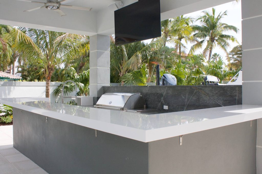 Mid-sized minimalist backyard concrete paver patio kitchen photo in Miami with a gazebo