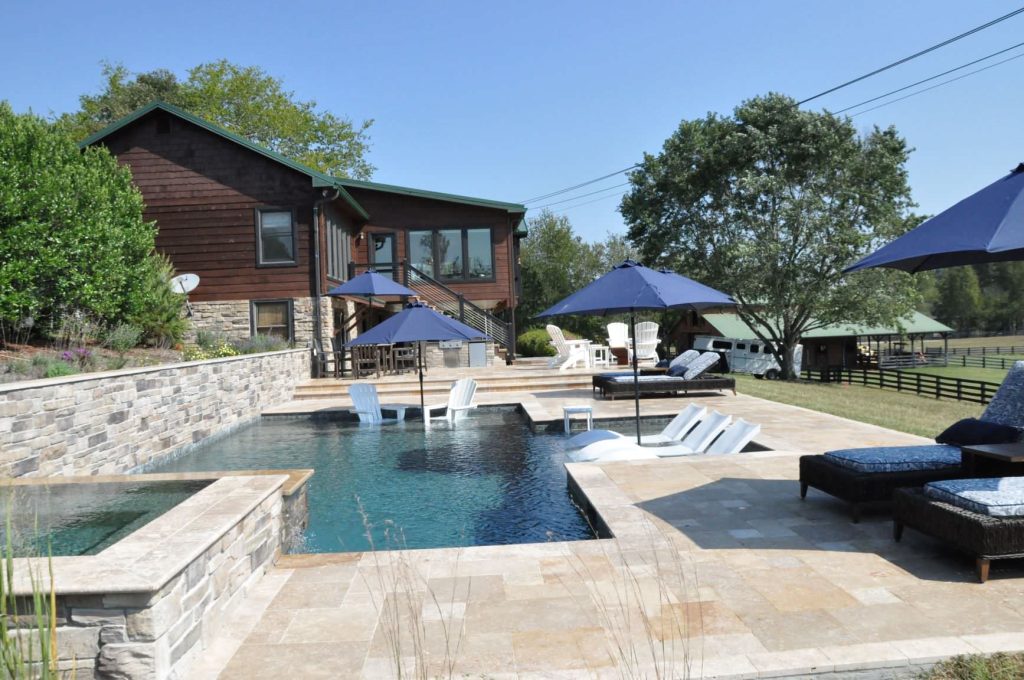 Mid-sized minimalist backyard stone and custom-shaped hot tub photo in Nashville