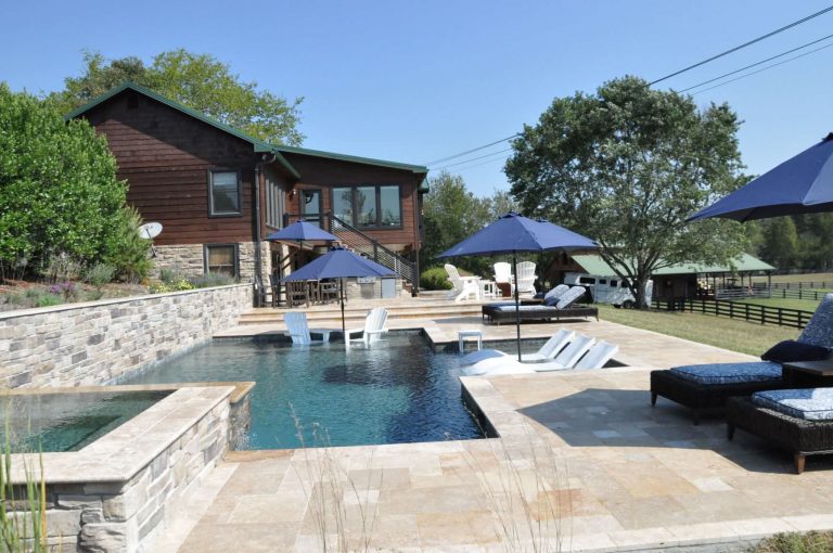 Mid-sized minimalist backyard stone and custom-shaped hot tub photo in Nashville