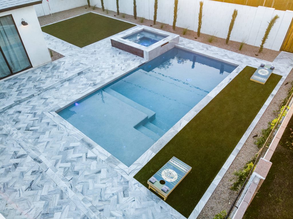 Mid-sized minimalist backyard stone and rectangular hot tub photo in Phoenix