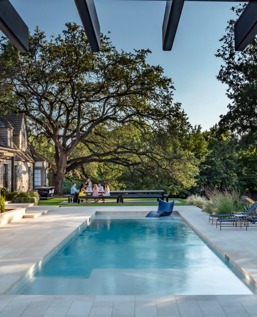Mid-sized minimalist backyard stone and rectangular pool landscaping photo in Austin