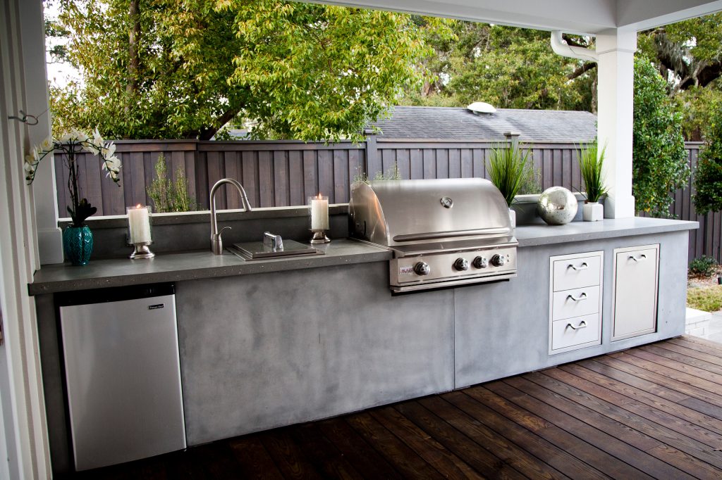 Mid-sized minimalist backyard stone patio kitchen photo in Jacksonville