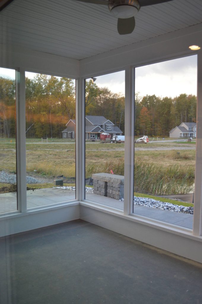 Mid-sized minimalist concrete paver screened-in back porch idea in Other with a roof extension by Bob Buescher Homes | Outdoor Photos | Porch | Landscaping | Landscape Design | Outdoor Living Space | Porch Design Ideas | Outdoor Living Space Ideas | Backyard Design