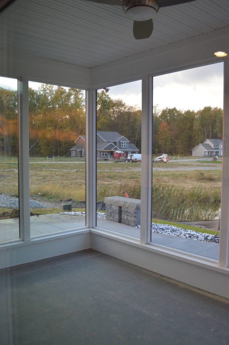 Mid-sized minimalist concrete paver screened-in back porch idea in Other with a roof extension by Bob Buescher Homes | Outdoor Photos | Porch | Landscaping | Landscape Design | Outdoor Living Space | Porch Design Ideas | Outdoor Living Space Ideas | Backyard Design