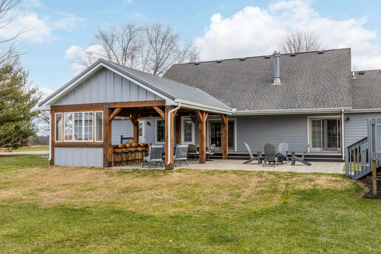 Mid-sized mountain style backyard brick patio kitchen photo in Columbus with a roof extension