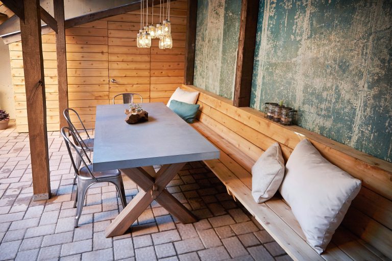 Mid-sized mountain style backyard brick patio kitchen photo in New York with a roof extension