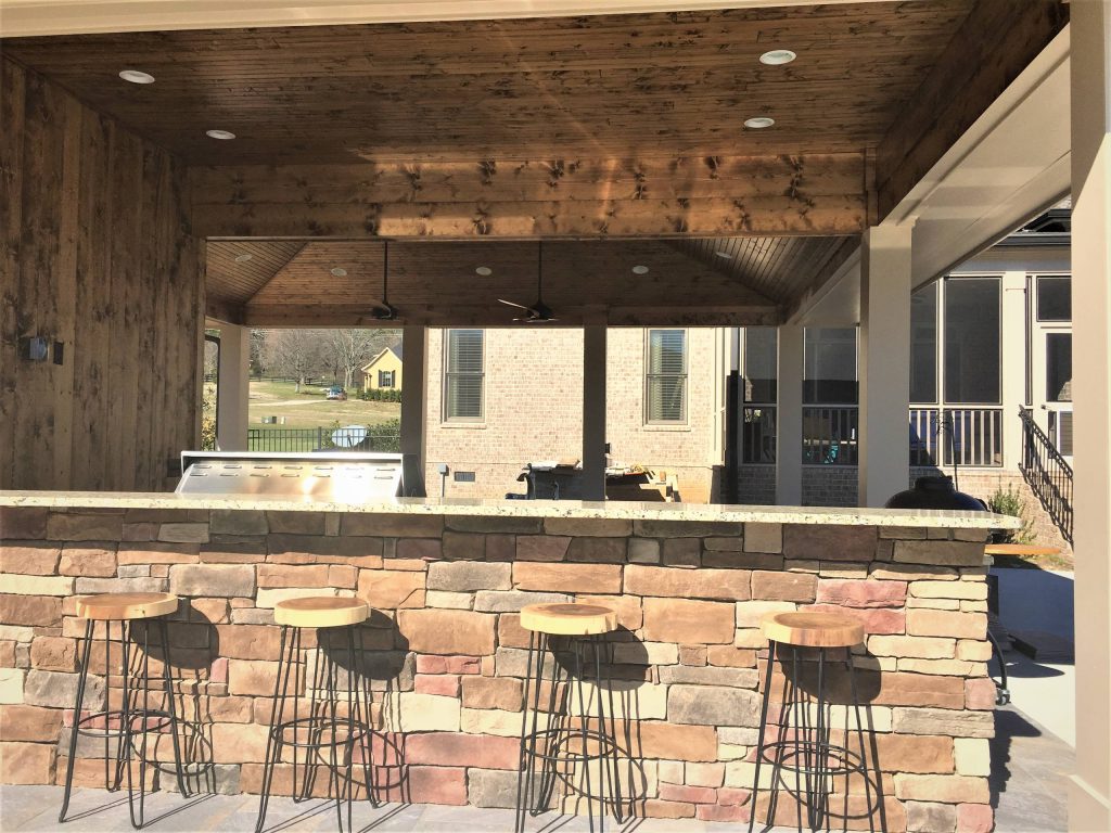Mid-sized mountain style backyard concrete patio kitchen photo in Nashville with a roof extension