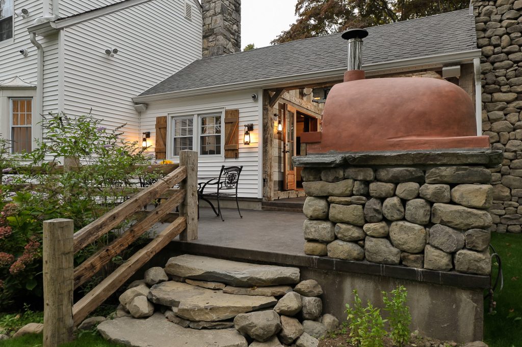 Mid-sized mountain style backyard concrete patio kitchen photo in New York with no cover