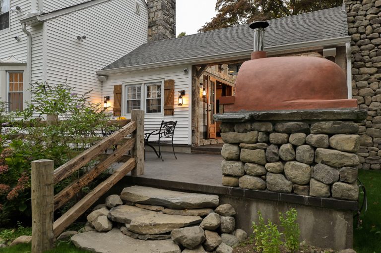 Mid-sized mountain style backyard concrete patio kitchen photo in New York with no cover