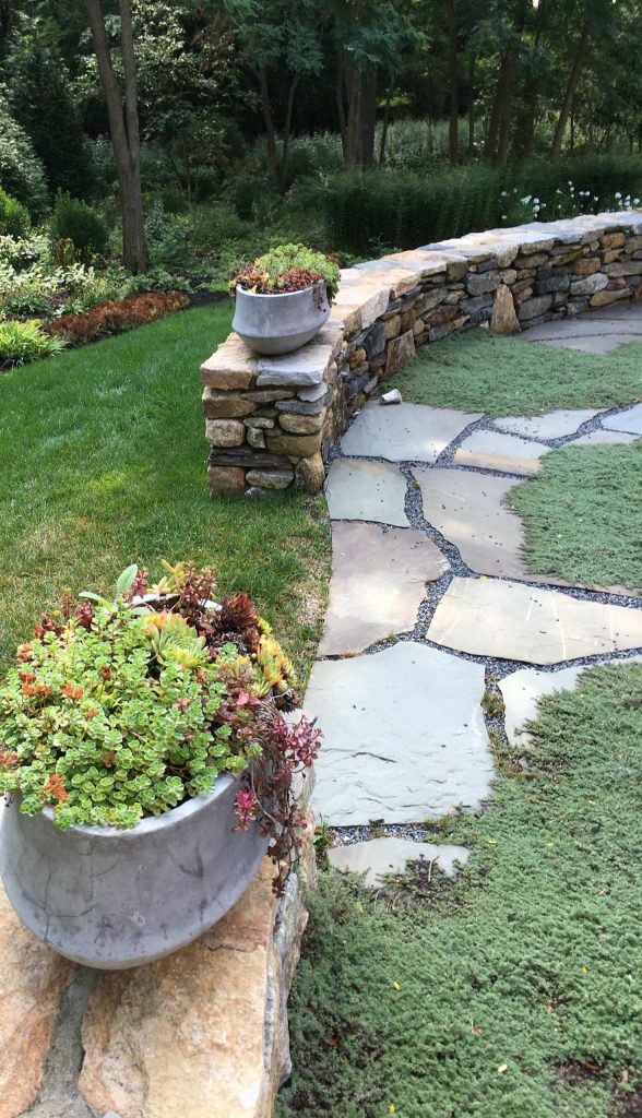 Mid-sized mountain style backyard stone patio kitchen photo in Boston with no cover