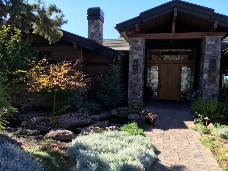 Mid-sized mountain style concrete paver front porch photo in Other with a roof extension by Siteplan | Outdoor Photos | Porch | Landscaping | Landscape Design | Outdoor Living Space | Porch Design Ideas | Outdoor Living Space Ideas | Backyard Design