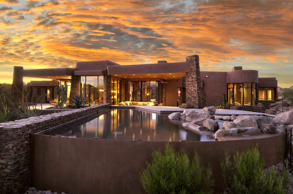 Mid-sized southwest backyard custom-shaped and concrete paver natural pool photo in Phoenix