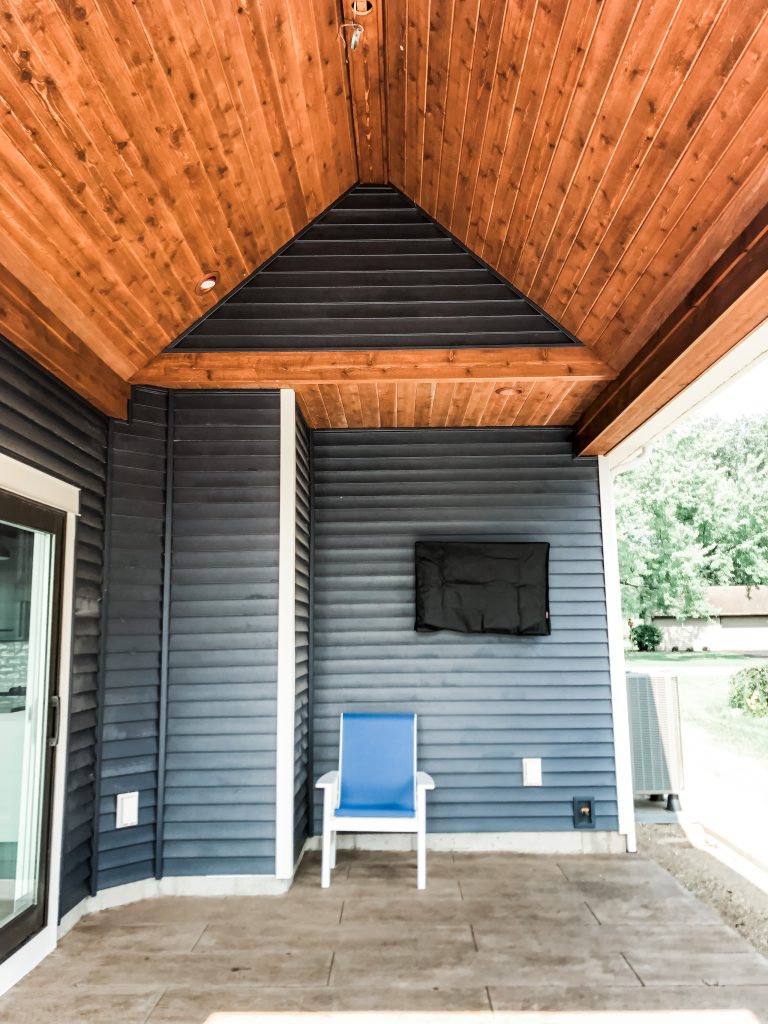 Mid-sized stamped concrete side porch photo in Other with a roof extension by Bob Buescher Homes | Outdoor Photos | Porch | Landscaping | Landscape Design | Outdoor Living Space | Porch Design Ideas | Outdoor Living Space Ideas | Backyard Design