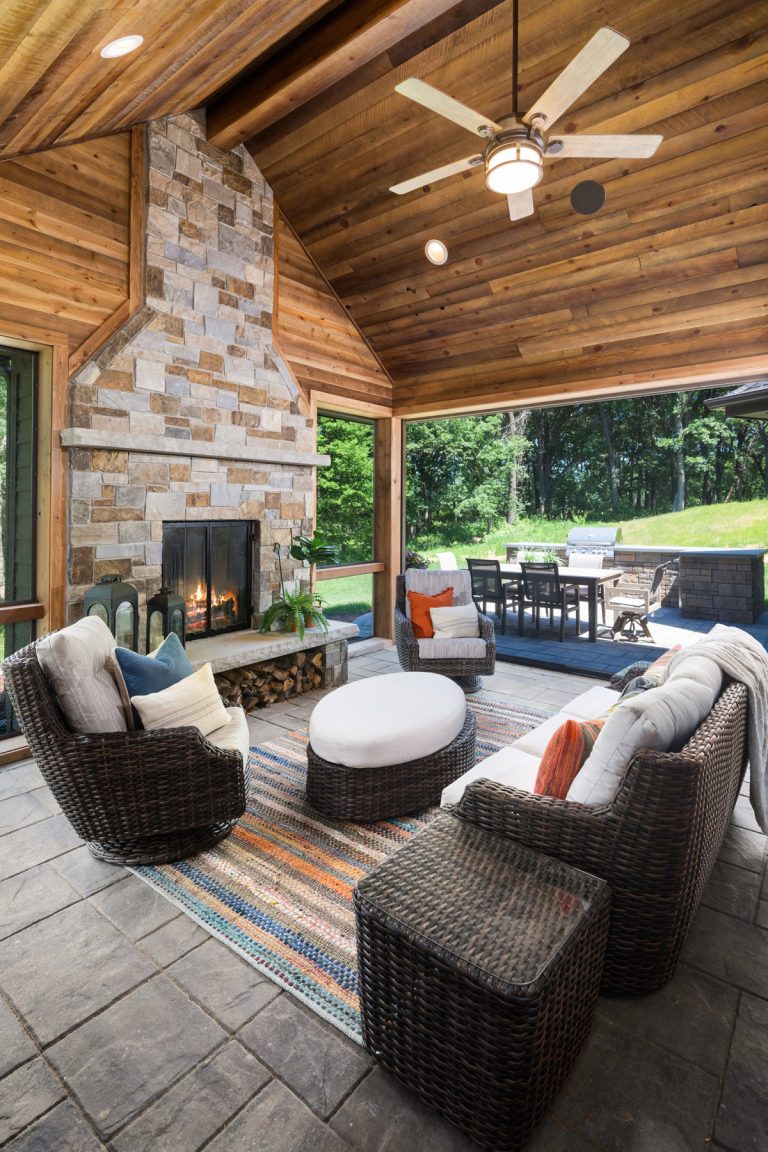 Mid-sized stone back porch idea in Minneapolis with a fireplace and a roof extension by Lecy Bros Homes & Remodeling | Outdoor Photos | Porch | Landscaping | Landscape Design | Outdoor Living Space | Porch Design Ideas | Outdoor Living Space Ideas | Backyard Design