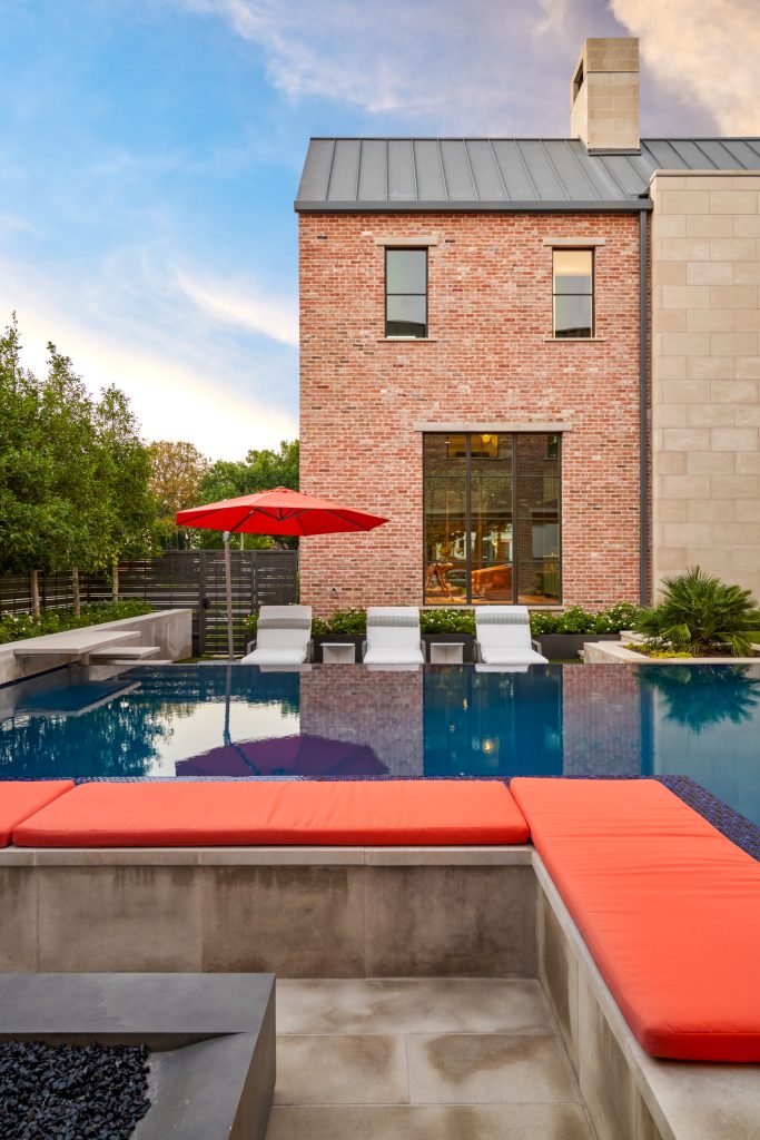Mid-sized transitional backyard concrete and l-shaped infinity pool photo in Dallas