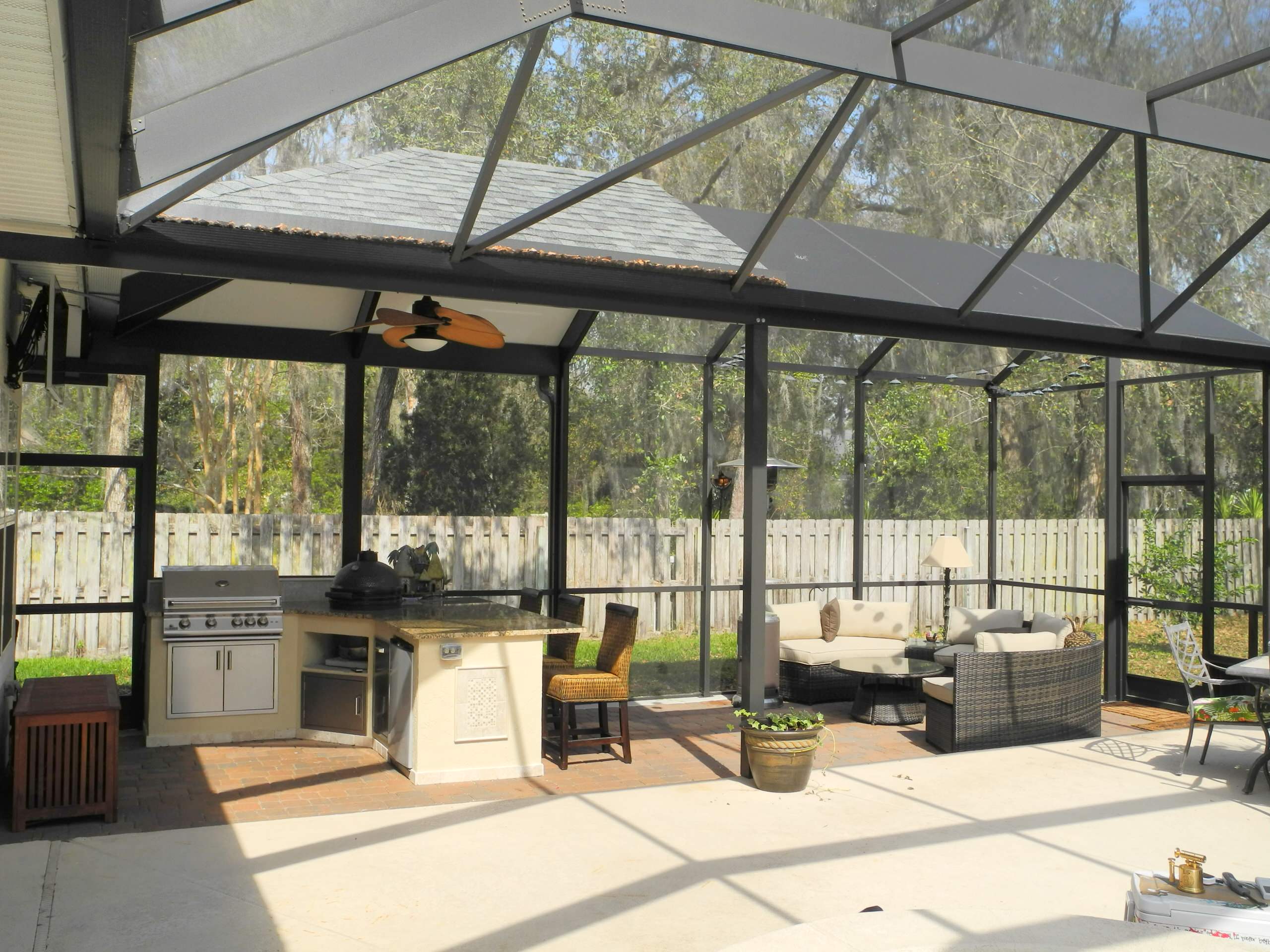 Mid-sized transitional backyard concrete paver patio kitchen photo in Jacksonville