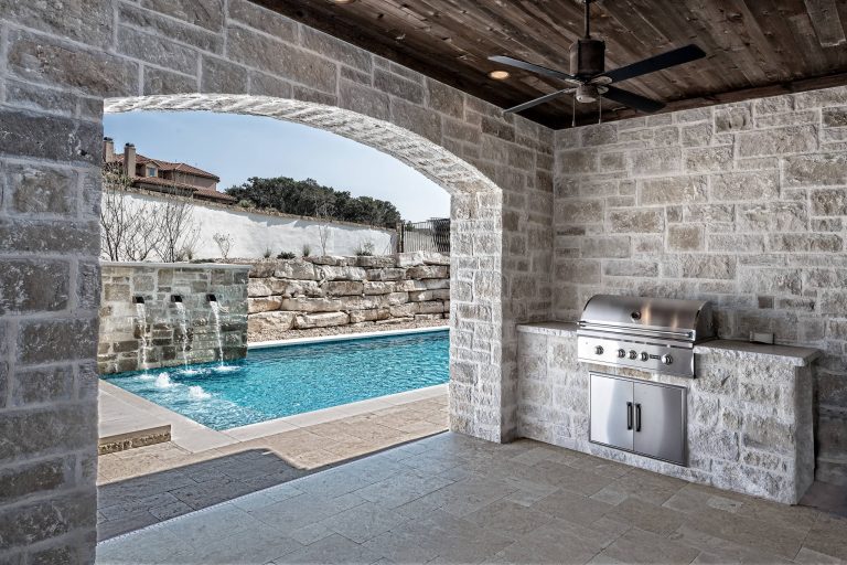 Mid-sized transitional backyard stamped concrete patio kitchen photo in Austin with a roof extension