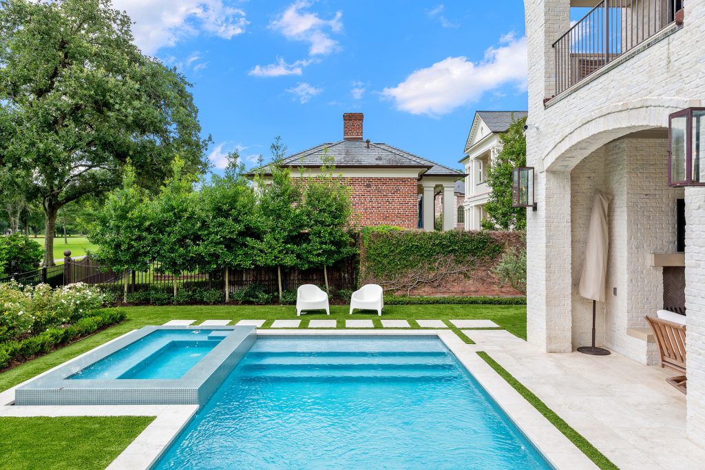 Mid-sized transitional backyard stone and rectangular hot tub photo in Houston