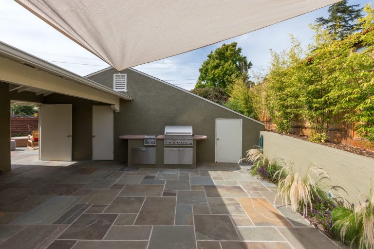 Mid-sized transitional backyard tile patio kitchen photo in San Francisco with an awning