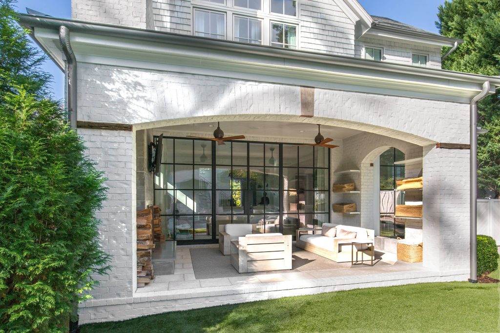 Mid-sized transitional concrete paver back porch photo in Atlanta with a fire pit and a roof extension by Curran & Co. Architects | Outdoor Photos | Porch | Landscaping | Landscape Design | Outdoor Living Space | Porch Design Ideas | Outdoor Living Space Ideas | Backyard Design