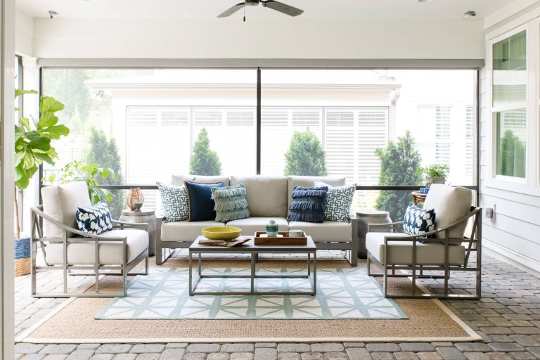 Mid-sized transitional concrete paver screened-in porch photo in Charlotte with a roof extension by Dwell by Cheryl Interiors | Outdoor Photos | Porch | Landscaping | Landscape Design | Outdoor Living Space | Porch Design Ideas | Outdoor Living Space Ideas | Backyard Design