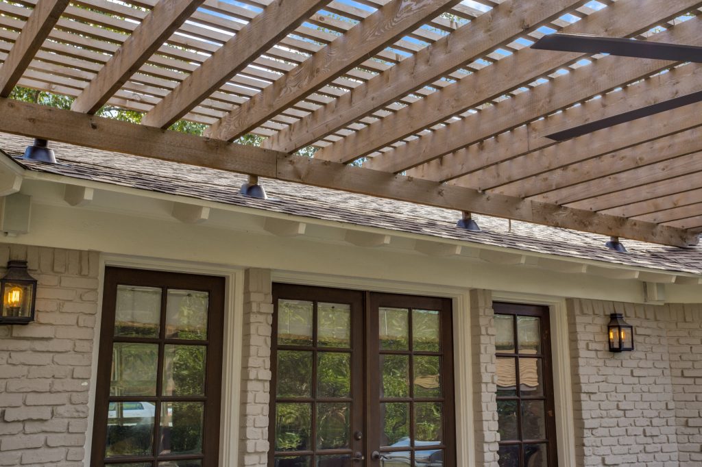 Mid-sized transitional concrete porch photo in Dallas with a pergola