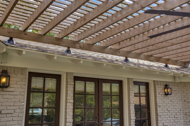 Mid-sized transitional concrete porch photo in Dallas with a pergola